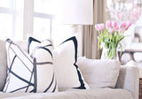 Channels Ebony & Ivory with Solid White with Grosgrain Ribbon Border Custom Designer Pillow on sofa | Arianna Belle 