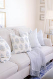 Blue luxury throw pillows on cream sofa | Mughal Flower Monsoon Blue and Green + Tika Dot Blue + Chinois Fret Blue Arianna Belle designer pillows
