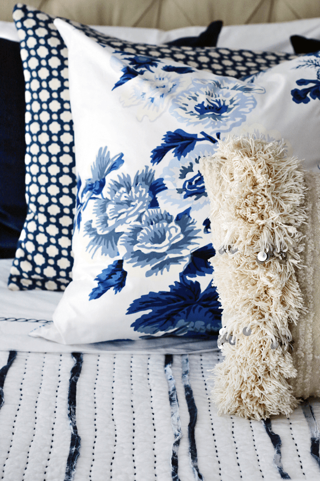 Betwixt Indigo Blue Custom Designer Pillow on bed with Pyne Hollyhock Indigo Designer Pillow | Arianna Belle